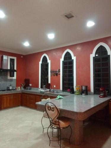 a large kitchen with red walls and a large table at Maria in Najem