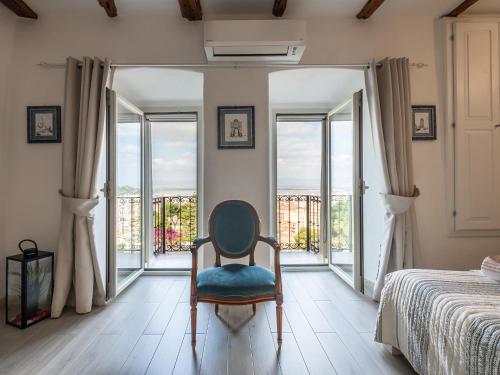 a room with a chair in front of a window at Karalis Relais in Cagliari