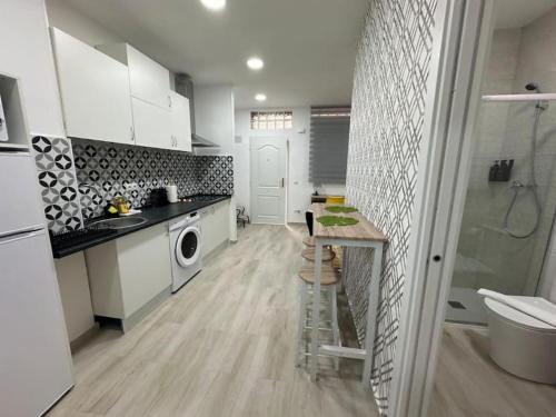 a kitchen with a sink and a washing machine at Martinez de la Riva I in Madrid