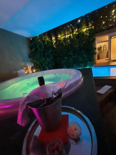 a table with a sink and a pool in the background at Clos des Thermes-Zanzibar in Liège