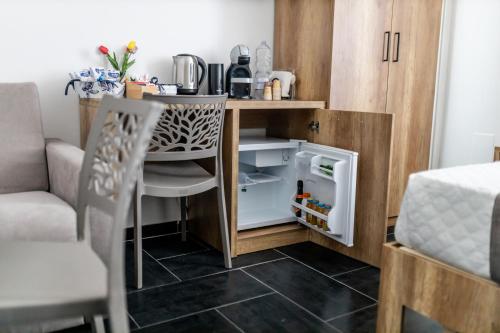 a small kitchen with a table and a small refrigerator at Mirellas dream in Vibo Valentia