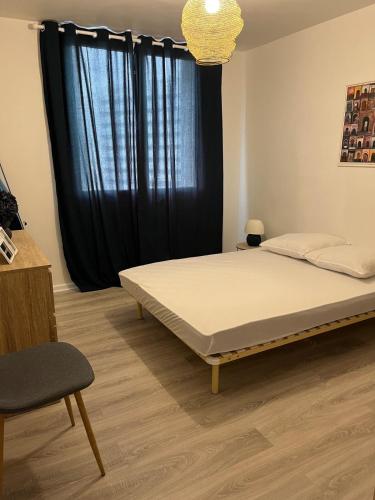 - une chambre avec un lit et une fenêtre noire dans l'établissement T2 Anglet City Center, à La Celle-sous-Gouzon