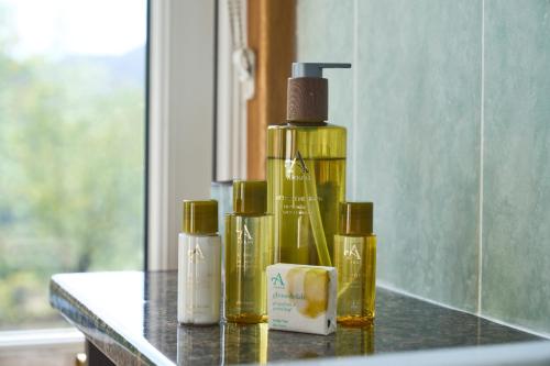 a group of three bottles of oil sitting on a counter at Stage House Bed & Breakfast in Glenfinnan