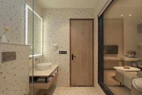 a bathroom with a sink and a toilet and a mirror at ECKO Tapovan by the Ganges in Rishīkesh