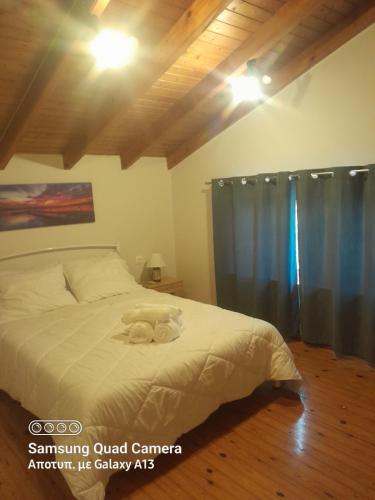 a bedroom with a bed with a stuffed animal on it at Harmony House Corfu in Kynopiástai