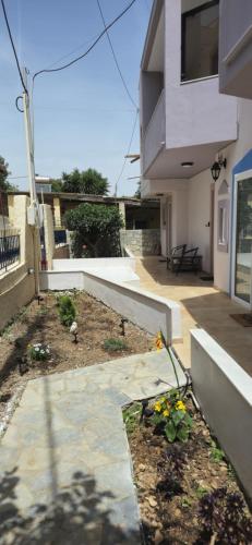 a garden in front of a house at GLIPTIS Apartments in Karfas