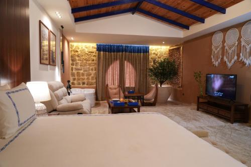 a bedroom with a large bed and a living room at venecia Resort Fayoum in Al Ḩammām
