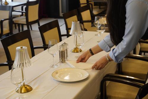 a person sitting at a table with a plate at Hotel Watermolen Le Mirage in Kasterlee