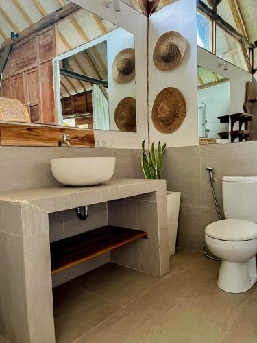 a bathroom with a sink and a toilet at Musa Bintang Villas and Bungalows Gili Air in Gili Air