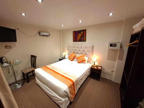 a hotel room with a large bed and a table at Andino Classic in Machu Picchu