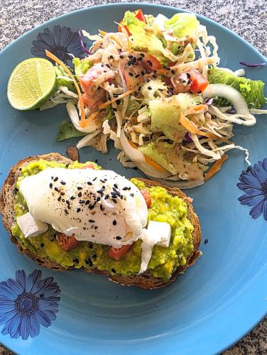 een blauw bord met een broodje en een salade bij Hideout Hostel 2 in Haad Rin