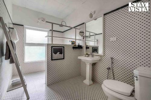 a bathroom with a toilet and a sink at The Estate Villa Where Luxury Meets Serenity in Suntikoppa