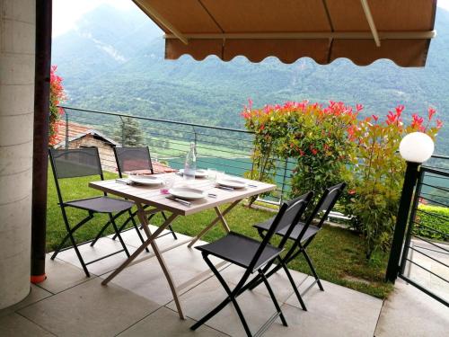 a table and chairs on a balcony with a view at DolceVita Apartment-your vacation on lakes in Carlazzo