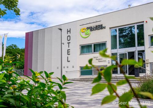a building with a sign on the side of it at College Garden Hotel in Bad Vöslau
