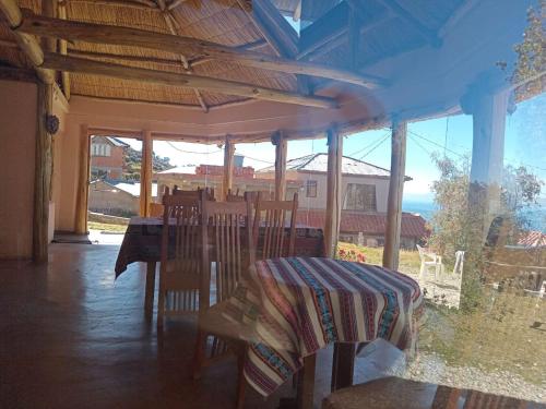 a dining room with a table and chairs with a view of the ocean at Casa de la Luna in Comunidad Yumani