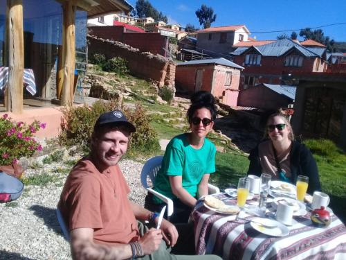 a group of people sitting at a table at Casa de la Luna in Comunidad Yumani
