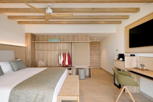 a hotel room with a bed and a tv at Iberostar Selection Es Trenc -New Opening- in Colonia Sant Jordi