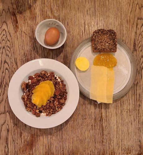 a table with plates of food with eggs and bread at TwentySix in Malmö