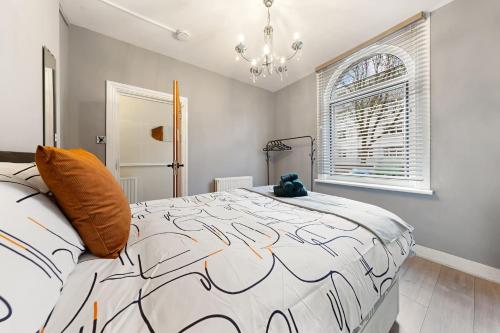 a bedroom with a large bed and a window at Lord’s Guesthouse - Room 2 in London