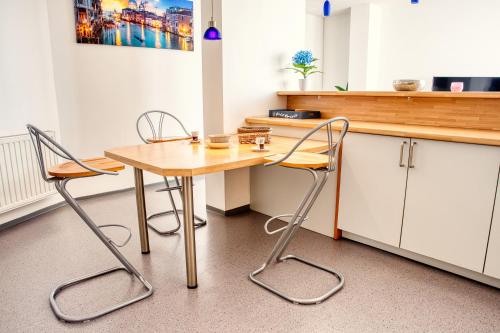 a kitchen with a wooden table and two chairs at Trackside Loft in Amberg