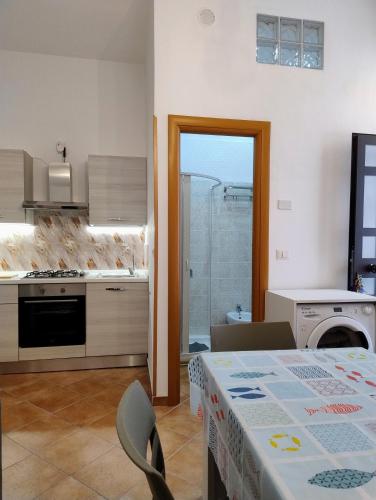 a kitchen and dining room with a table and a dining room at Al VICO TREDICI in Gaeta