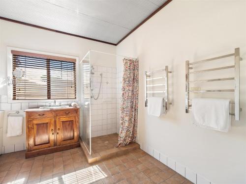 a bathroom with a sink and a shower at Margs In Mandurah- Classic Family Holiday Abode! in Dawesville