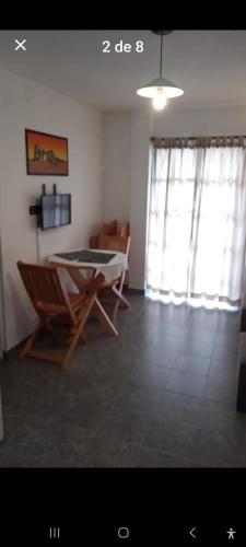 a living room with a table and chairs in it at Edifico MF in Posadas