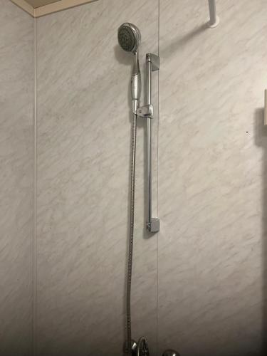 a shower in a bathroom with a shower head at Cheap Apartment near airport with included parking, washer and dryer Always Ready Finhaugveien 5 in Evenesmarkja