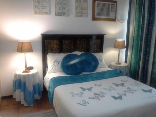 a bedroom with a bed with a blue ball on it at La Rochelle Inn in Richards Bay