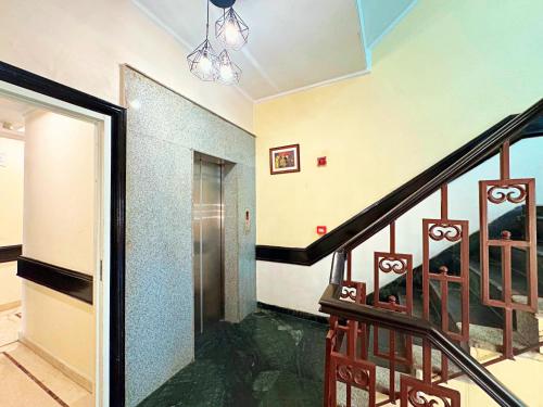 a hallway with a staircase with a glass door and a stairwayexit at The Oakland Plaza by Orion Hotels in New Delhi