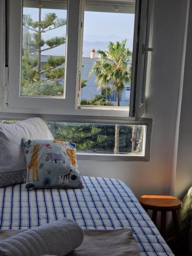 a bedroom with two windows and a bed with a pillow at Sea and Mountains in Gran Alacant