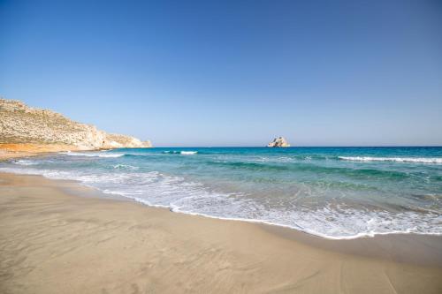 a sandy beach with the ocean in the background at Amatu Villa (Athena) in Xerokampos