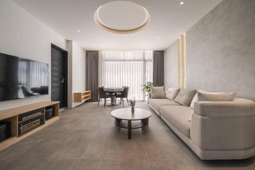 a living room with a couch and a table at kk villa in Dongshan
