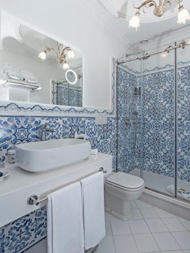 a bathroom with a sink and a toilet and a shower at Hotel Quisisana in Capri
