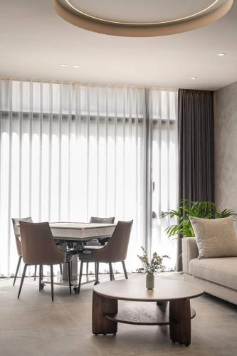 a living room with a table and chairs and a couch at KK Villa in Dongshan