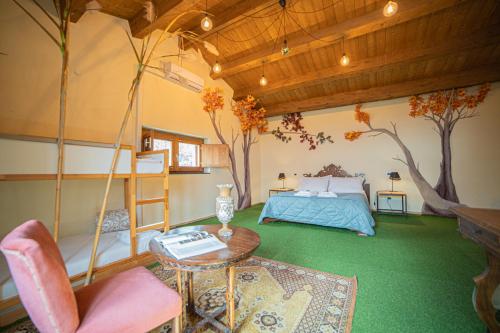 a bedroom with a bed and a table and a tree at Boscoscuro in Ragalna