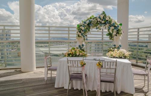 a table with a floral arch and chairs on a balcony at Park Avenue Rochester in Singapore