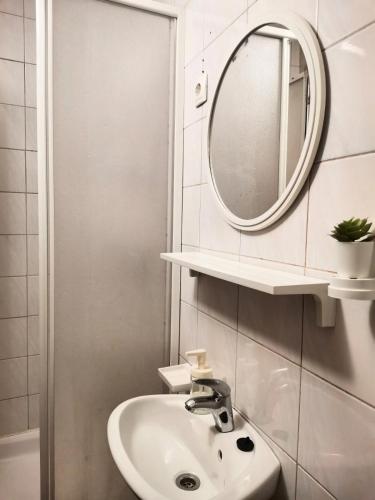 a bathroom with a sink and a mirror at Sobe Pri Olivi in Kobarid