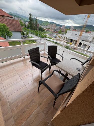 a balcony with two chairs and a table on a roof at Hotel Avanti in Zenica