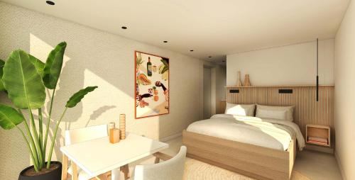 a bedroom with a bed and a table and a plant at Het Witte Huis B&B in Kollum