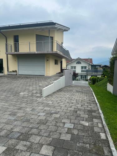 a house with a brick driveway in front of a house at Komfortable Ferienwohnung in Beckenried, Nidwalden in Beckenried