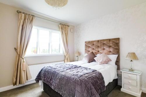a bedroom with a large bed and a window at Sea Mist Guesthouse in Galway