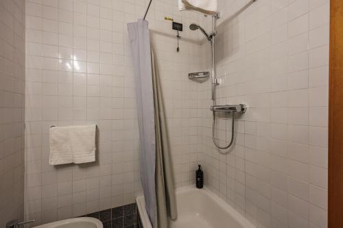 a bathroom with a shower and a tub and a toilet at Hotel alla Grotta in Lazise