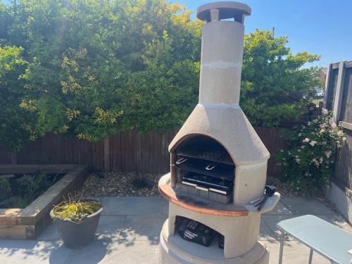 a stone oven sitting in a backyard with a fence at Seafront BnB at Botany in Kent