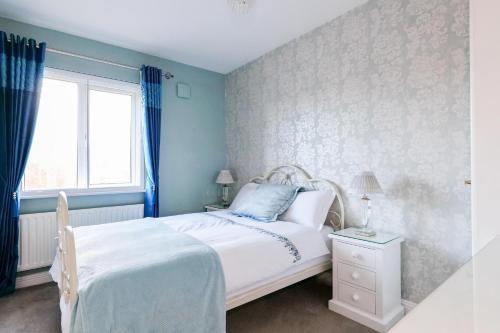 a bedroom with a white bed and a window at Sea Mist Guesthouse in Galway
