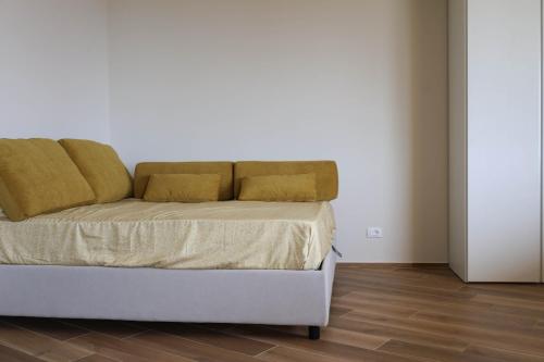 a bed with two pillows on it in a room at La Gialla Attico dAmore in Padenghe sul Garda
