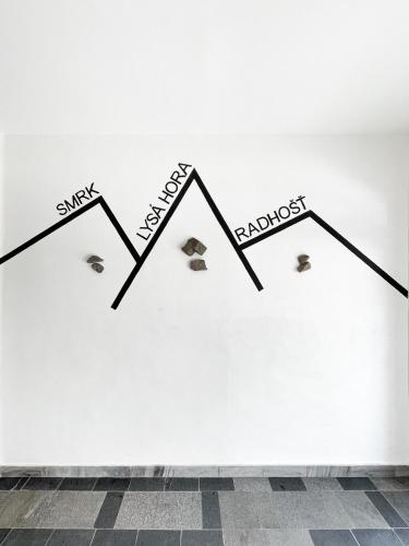 a wall with a drawing of three mountains on it at Beskydy House in Rožnov pod Radhoštěm