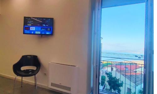 a room with a tv and a window with a view at Vicolò Marì in Ascea