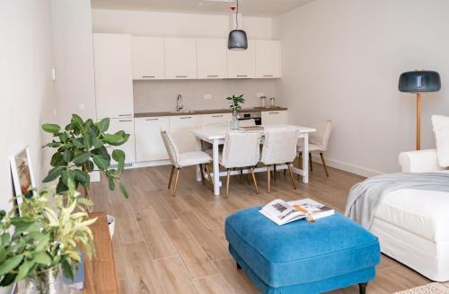 a kitchen and living room with a table and chairs at Lustica Bay Piazza Apartment in Radovići
