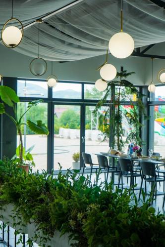 a dining room with a table and chairs and lights at Tulipan Hotel Aquapark in Vyshkove